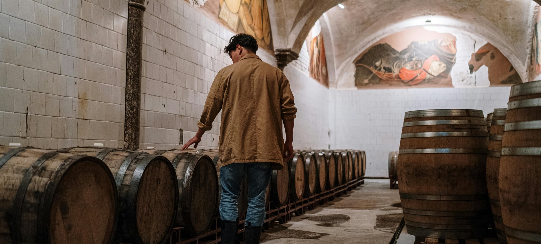 Man looking at barrels